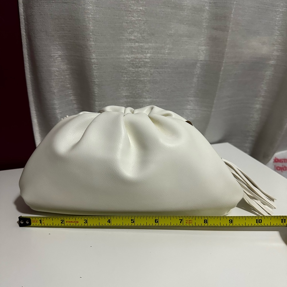 NWOT understated leather white/bone clutch with tassel